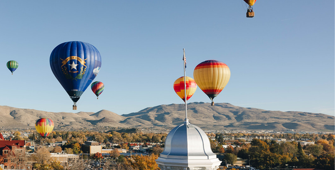 Carson City Capitol Dome centered around fall trees and hot air balloons